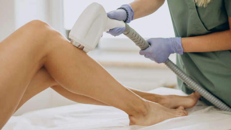 Laser hair removal treatment on a woman’s legs